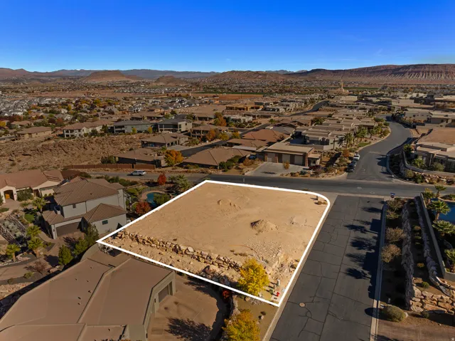 Aerial perspective of suburban area with a mountain backdrop and property boundaries highlighted