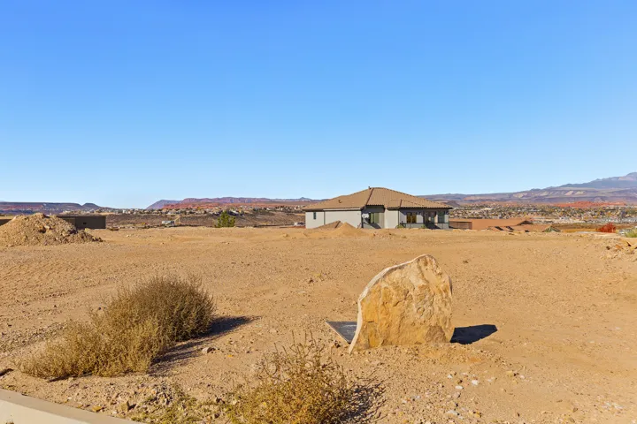 View of yard featuring a mountain view and view of desert landscape