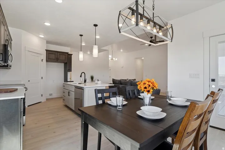 Dining room with light wood-type flooring and recessed lighting