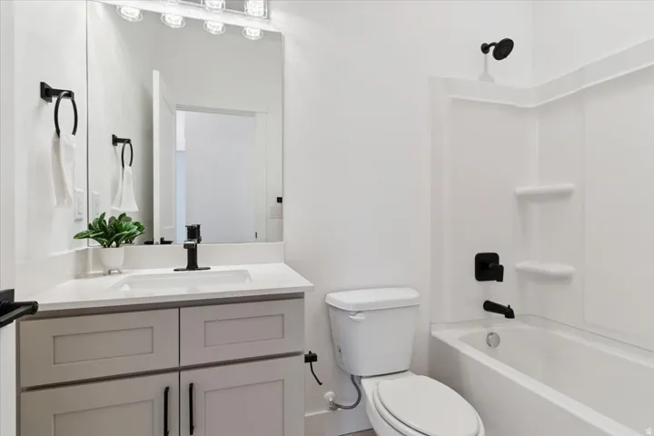 Full bath featuring  shower combination and vanity