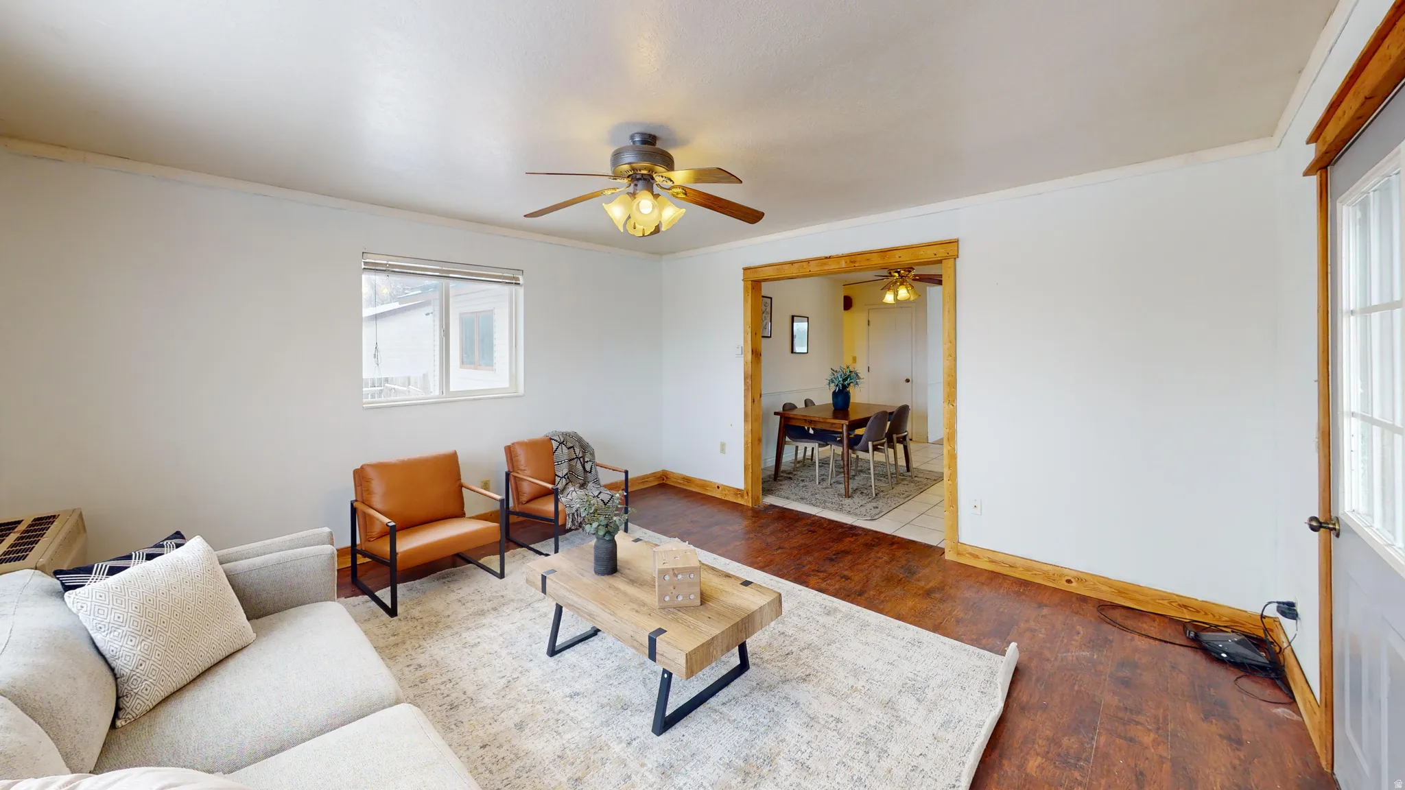 Living room with hardwood / wood-style flooring, ceiling fan, and crown molding