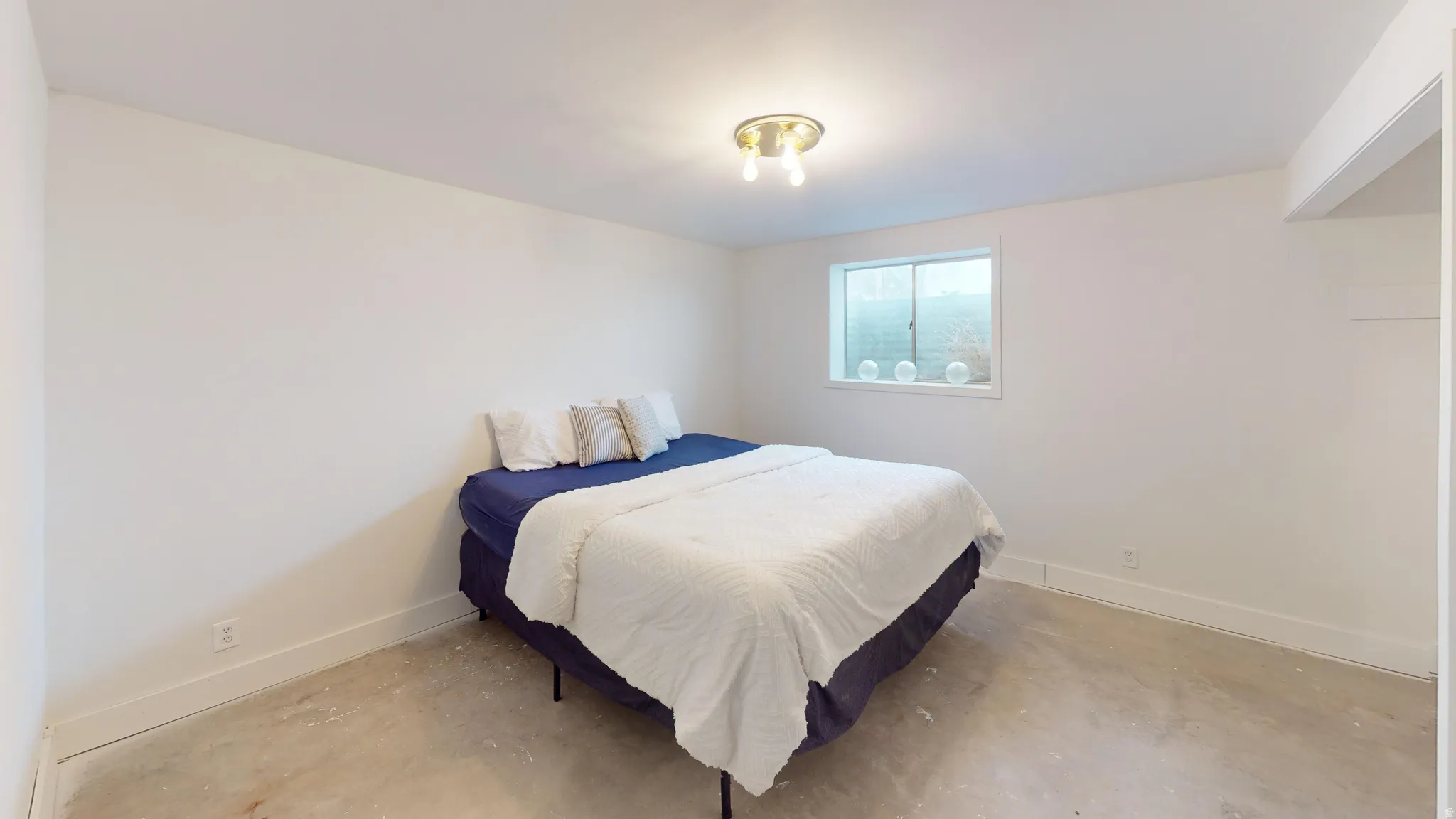 Bedroom featuring concrete floors