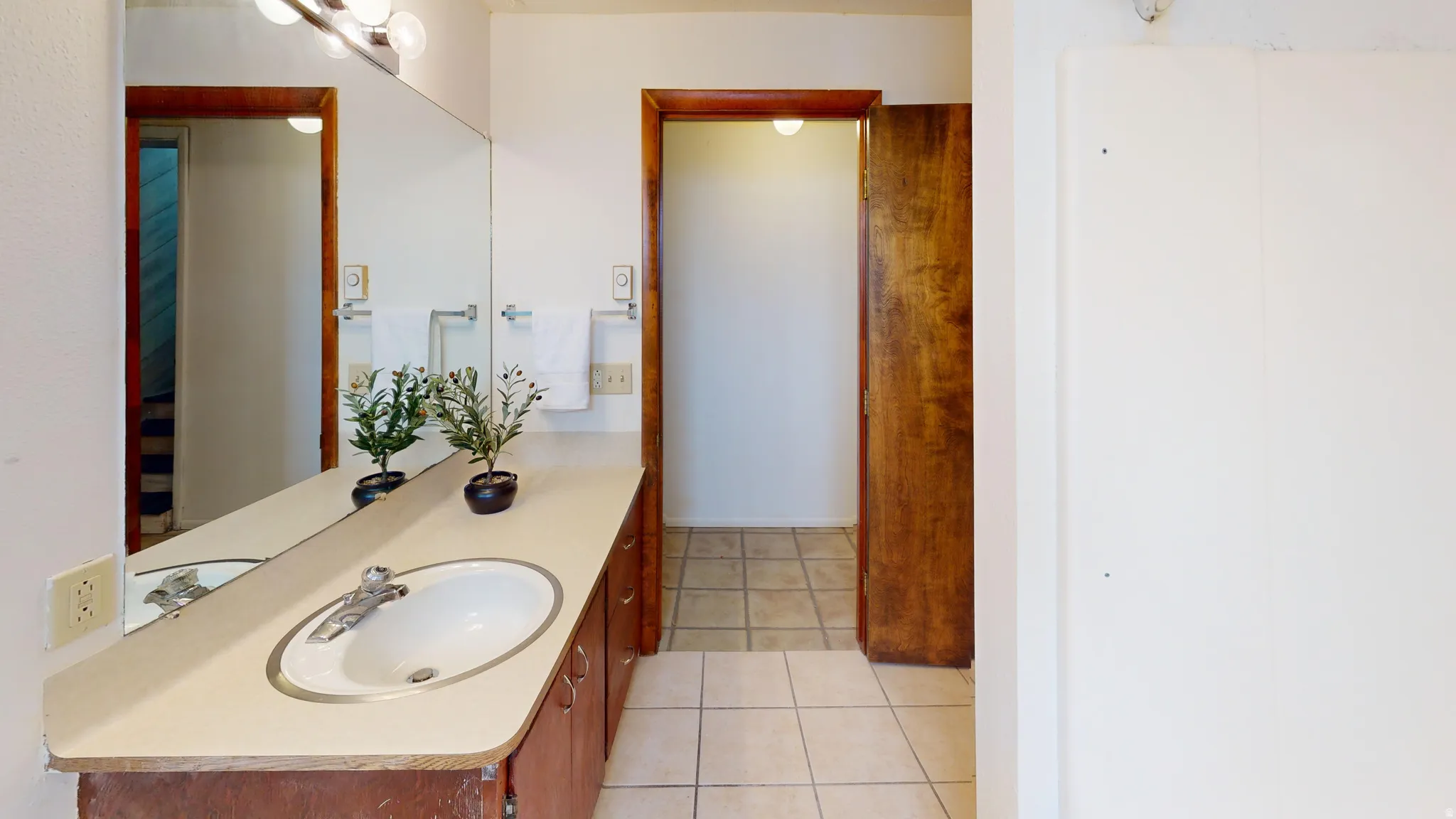 Bathroom featuring vanity and light tile patterned floors
