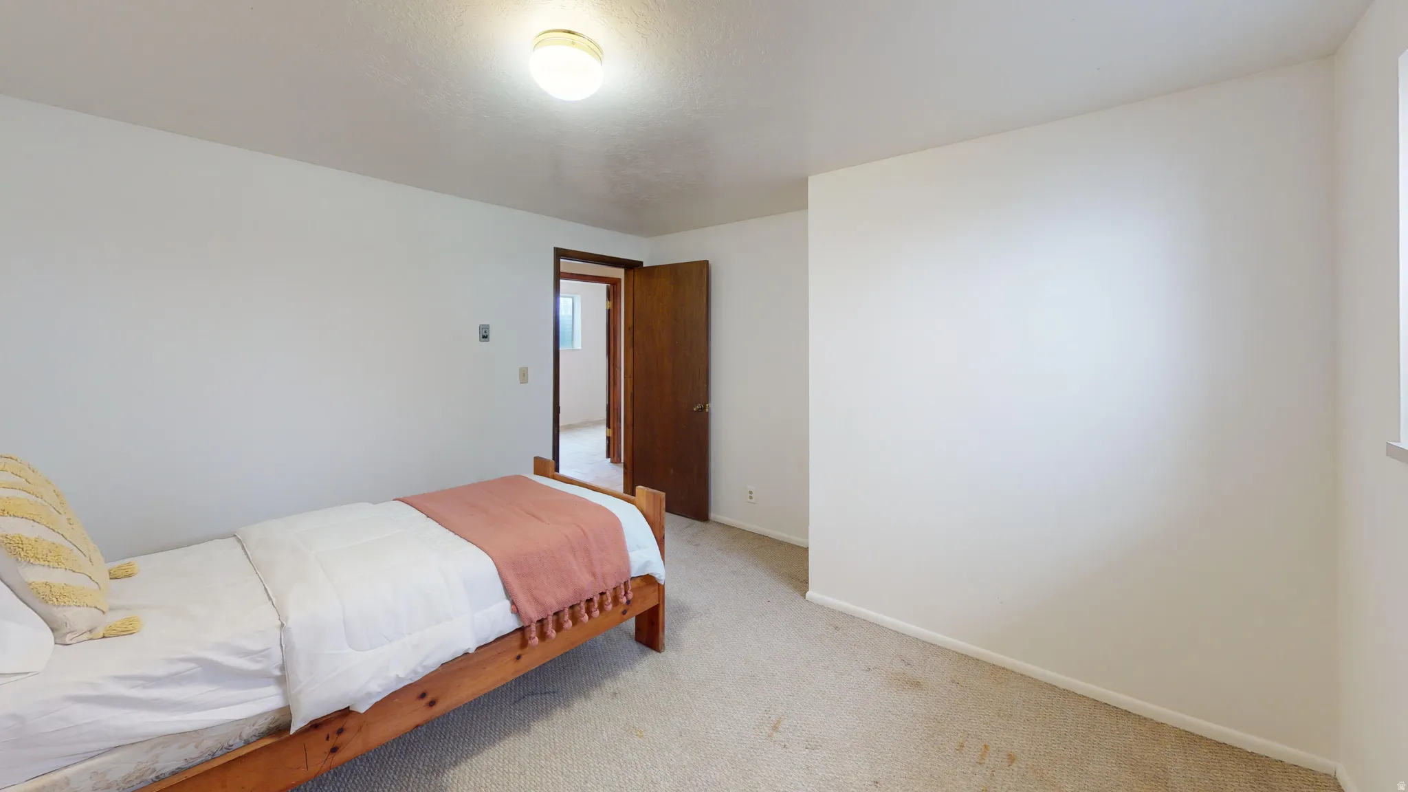 Bedroom featuring carpet flooring and baseboards