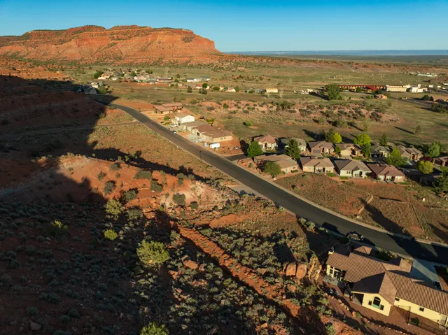 Aerial view of property and surrounding area with a mountain backdrop