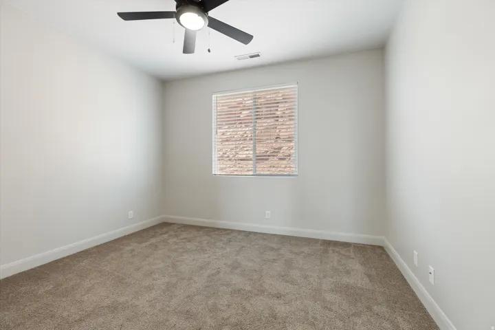 Neutral-toned walls complement the plush carpeting