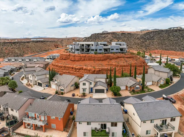 Residential neighborhood featuring a curved street, single-family homes with pitched roofs, and varied exterior finishes