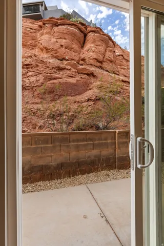 Patio with concrete slab, block retaining wall, and rock landscaping