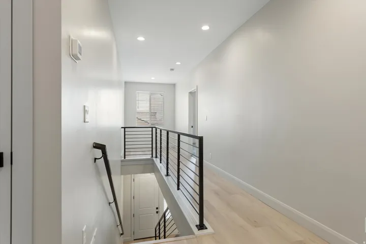 Light wood-finish flooring with recessed lighting