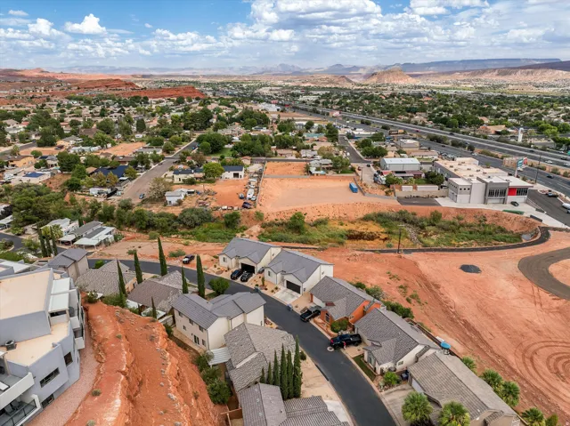 Aerial perspective showcasing a residential development with surrounding natural desert landscape and distant mountains