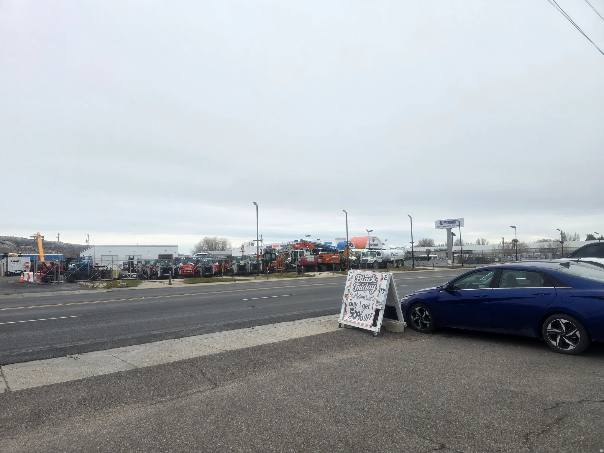 View of asphalt street featuring street lights