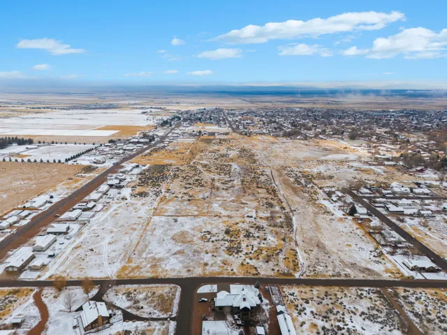 Snowy aerial view featuring a residential view