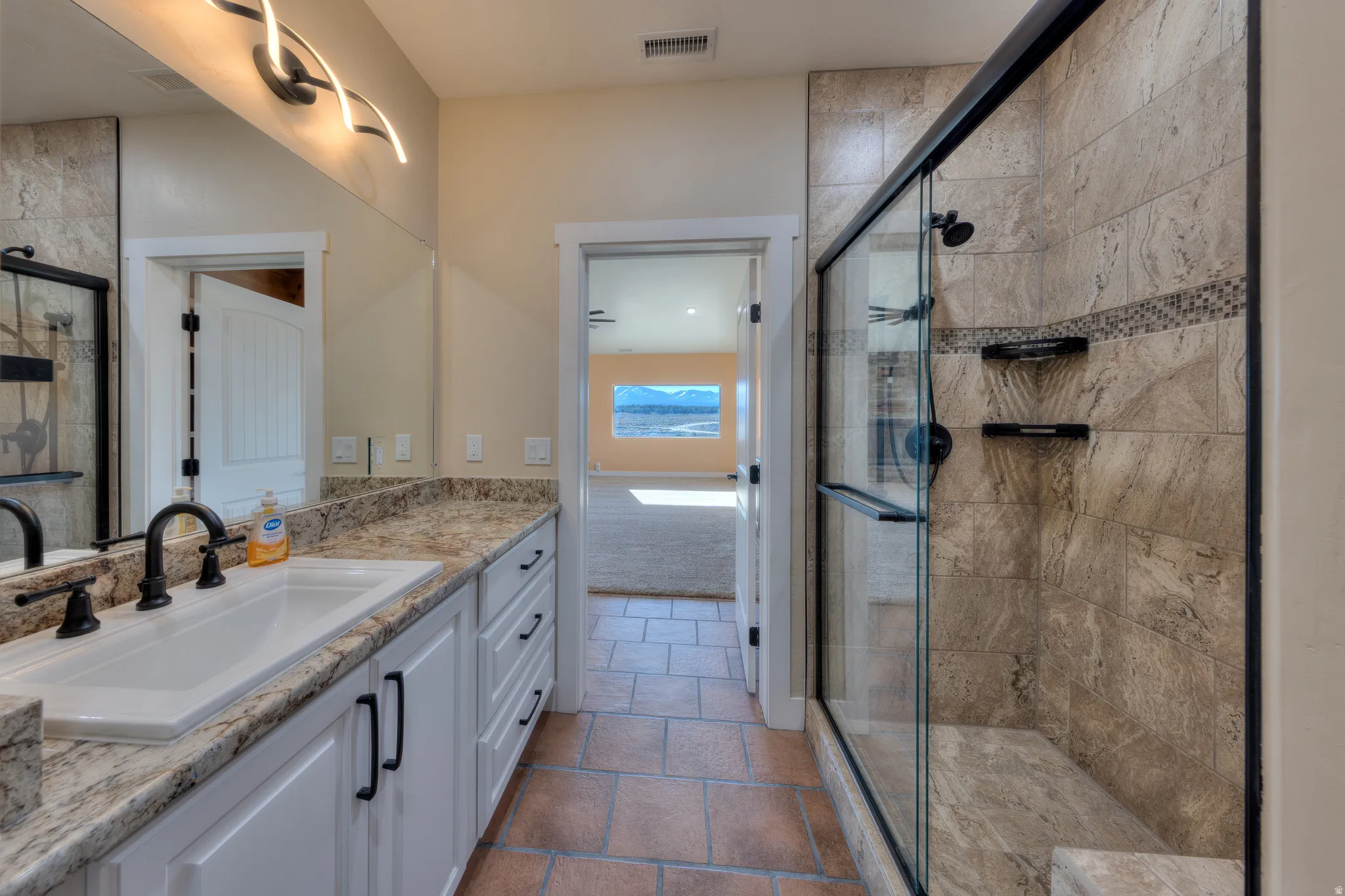 Bathroom with vanity and a stall shower