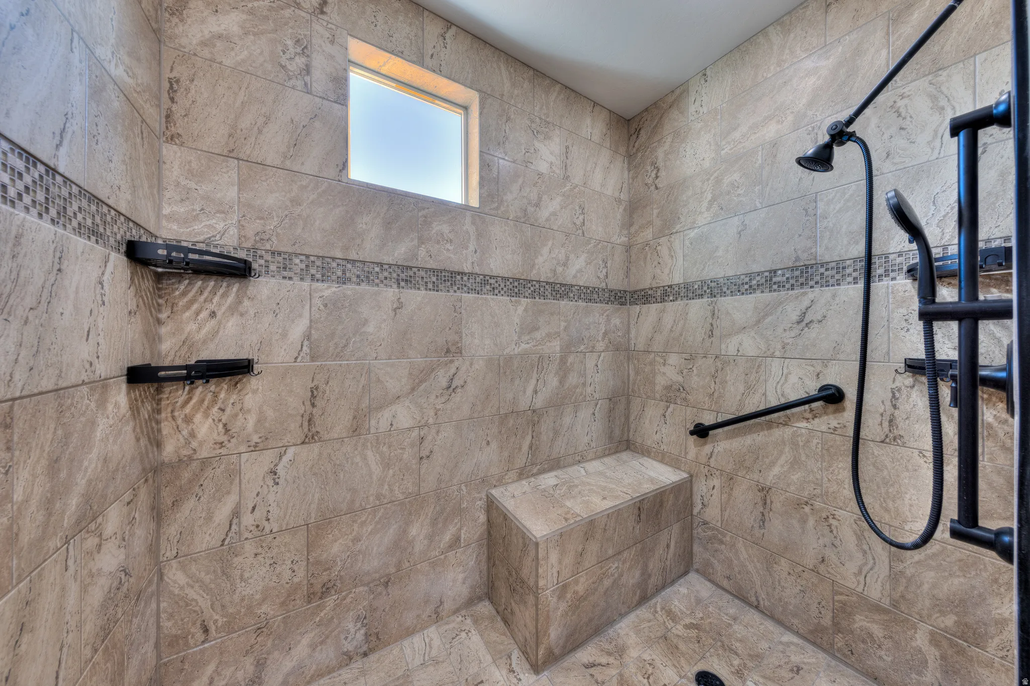 Full bathroom featuring a tile shower