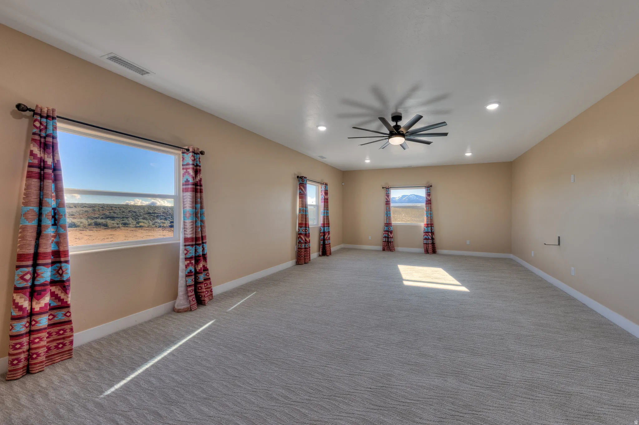 Carpeted spare room with recessed lighting and a ceiling fan
