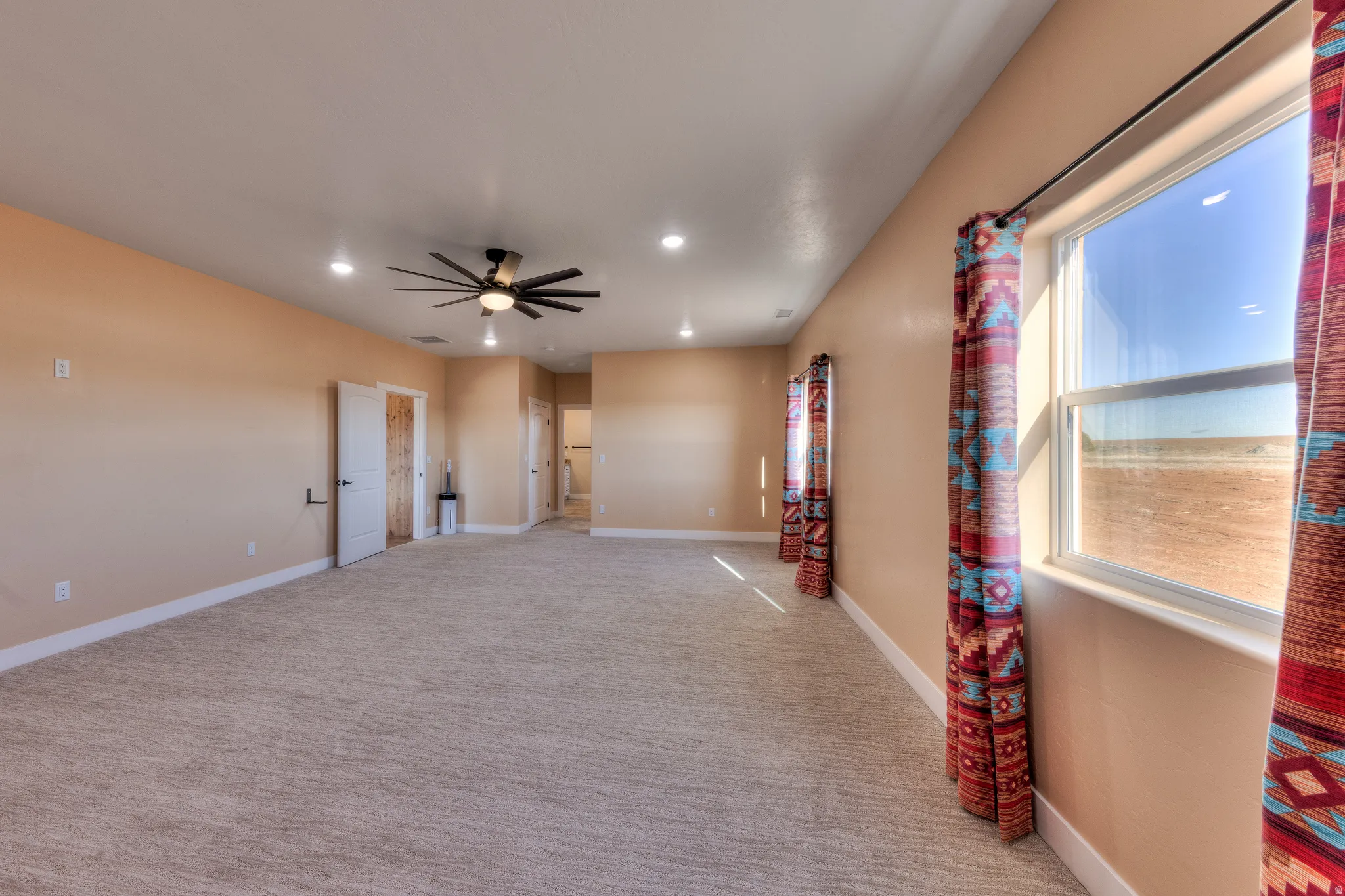 Empty room with light carpet, recessed lighting, and ceiling fan