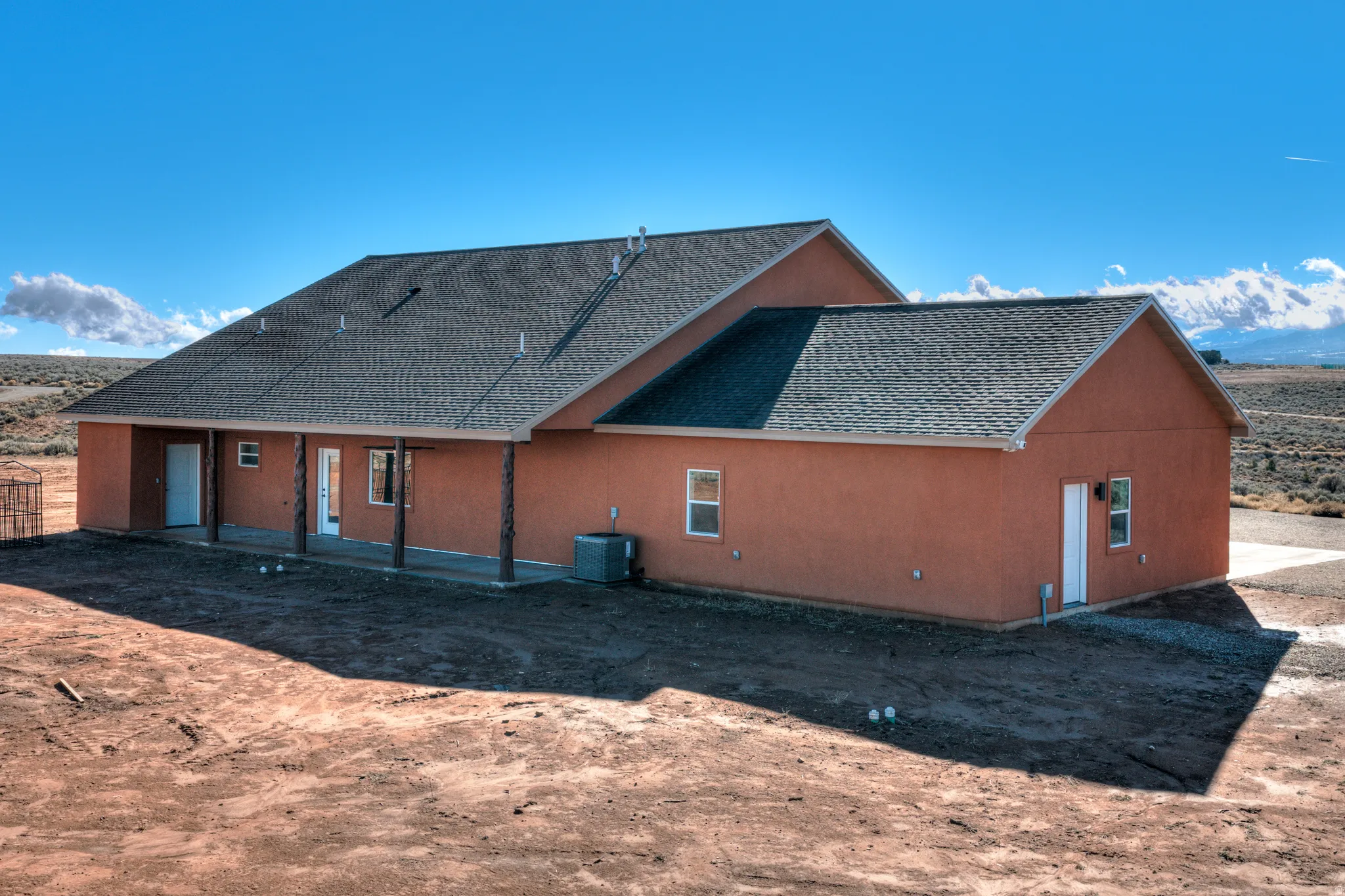 Rear view of property with roof with shingles, a patio area, and stucco siding