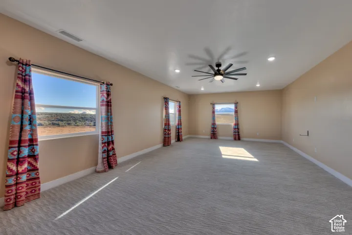 Carpeted spare room with recessed lighting and a ceiling fan