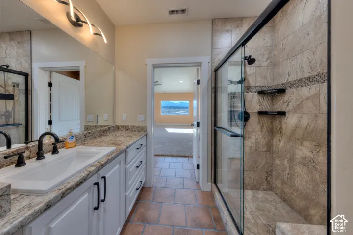 Bathroom with vanity and a stall shower