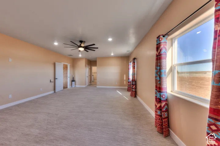 Empty room with light carpet, recessed lighting, and ceiling fan