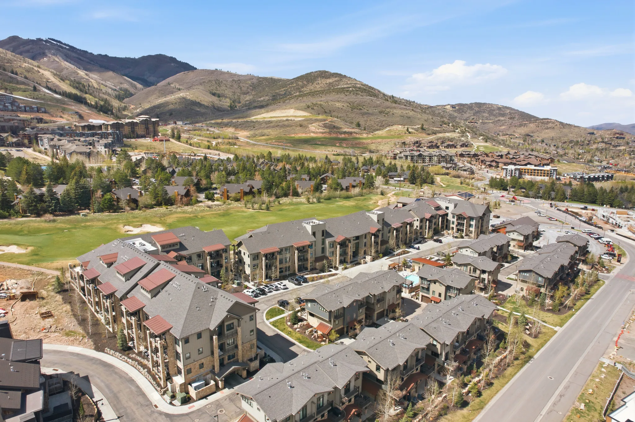 Residential development featuring multi-story buildings with pitched roofs and exterior balconies
