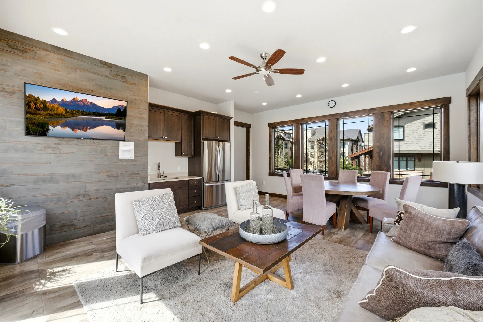 Open-concept living space featuring wood-finish flooring, recessed lighting, and a ceiling fan