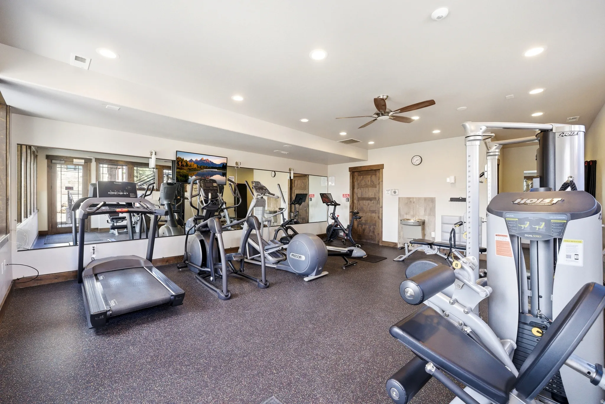 Fitness room featuring rubberized flooring and mirrored walls