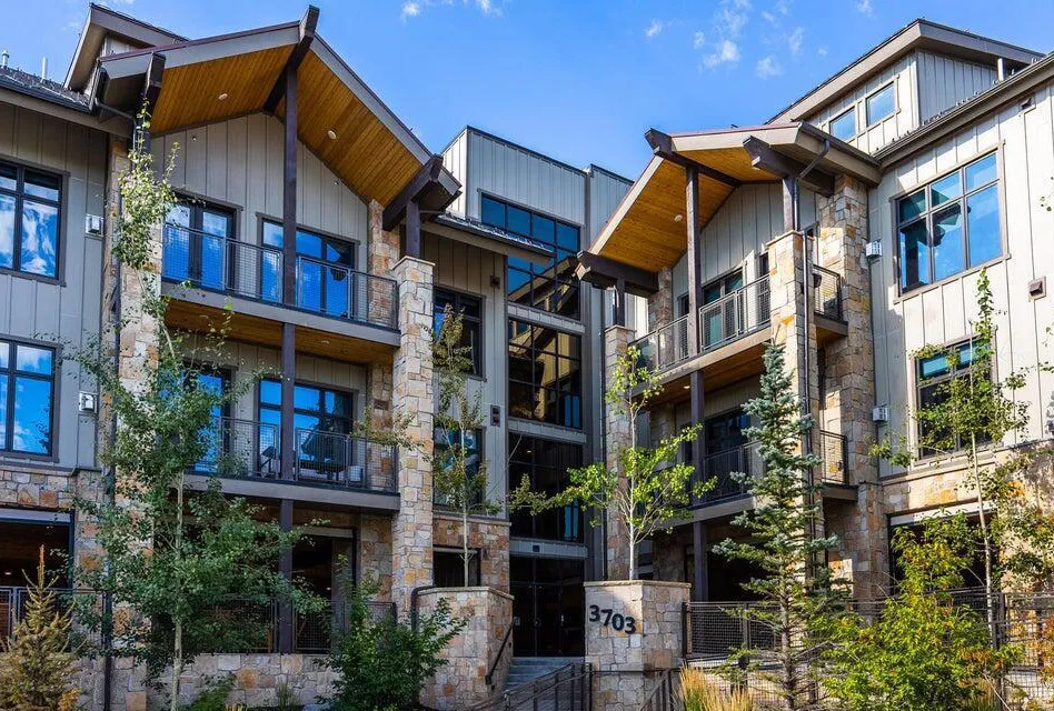 Multi-story building with stone and vertical siding exterior