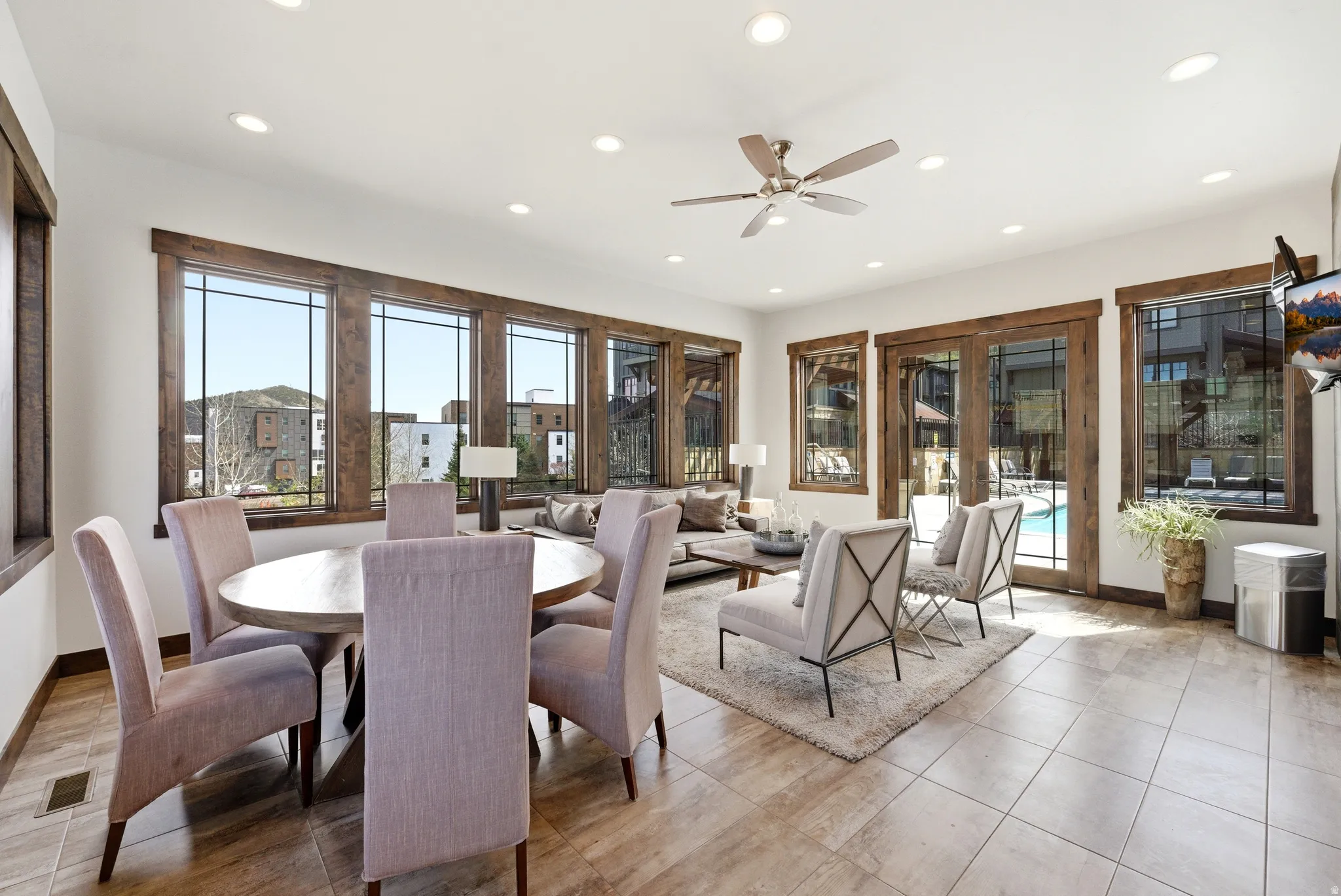 Open-concept living space featuring wood-finish window and door trim