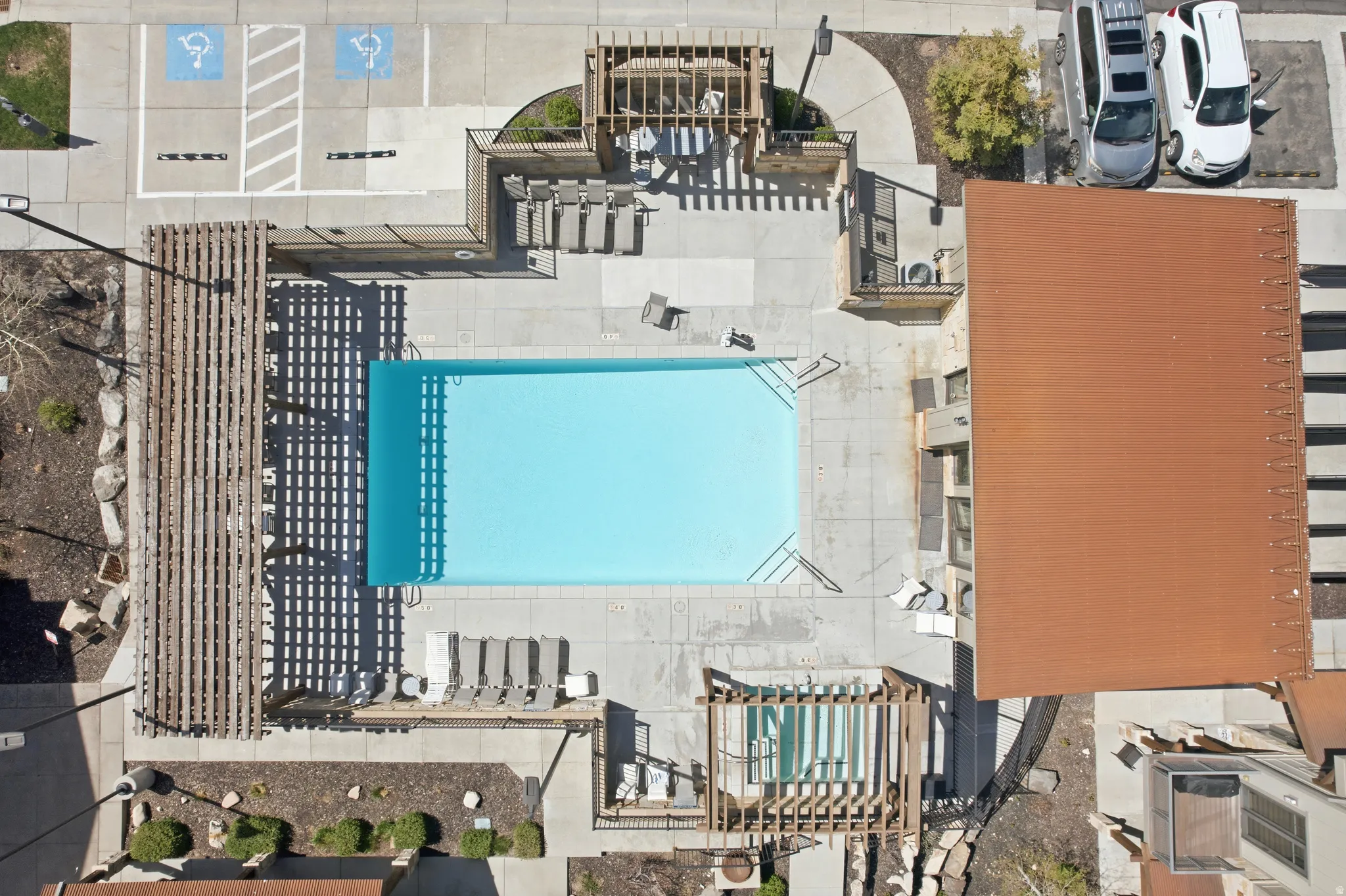 Rectangular swimming pool with integrated steps, surrounded by a concrete deck