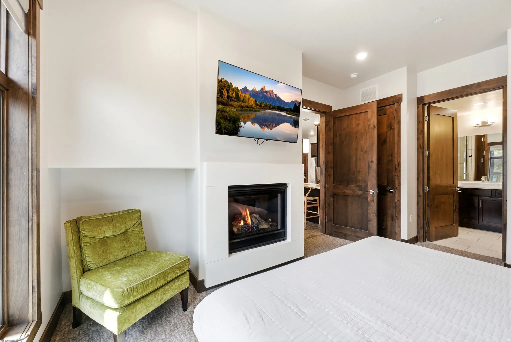 Fireplace with a sleek white surround and mounted television