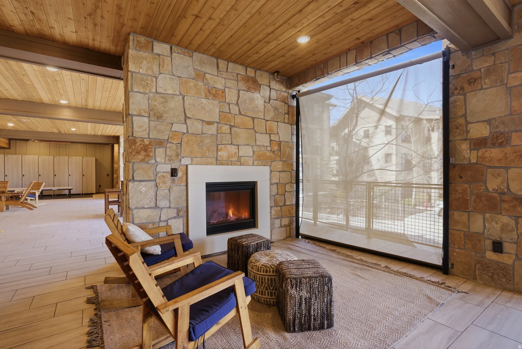 Stone accent wall featuring a built-in fireplace with a white surround
