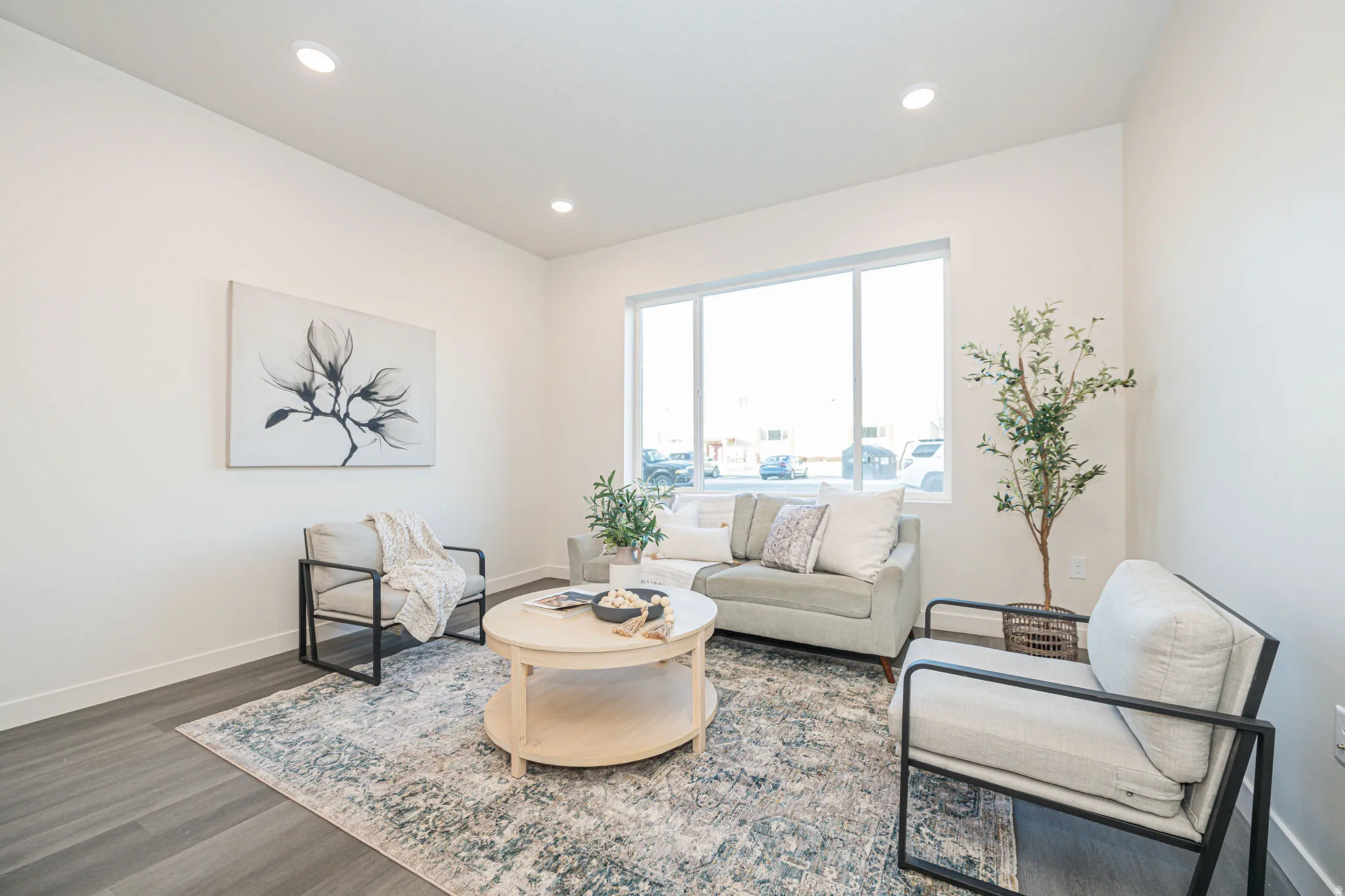 Living area featuring dark wood-style flooring and recessed lighting