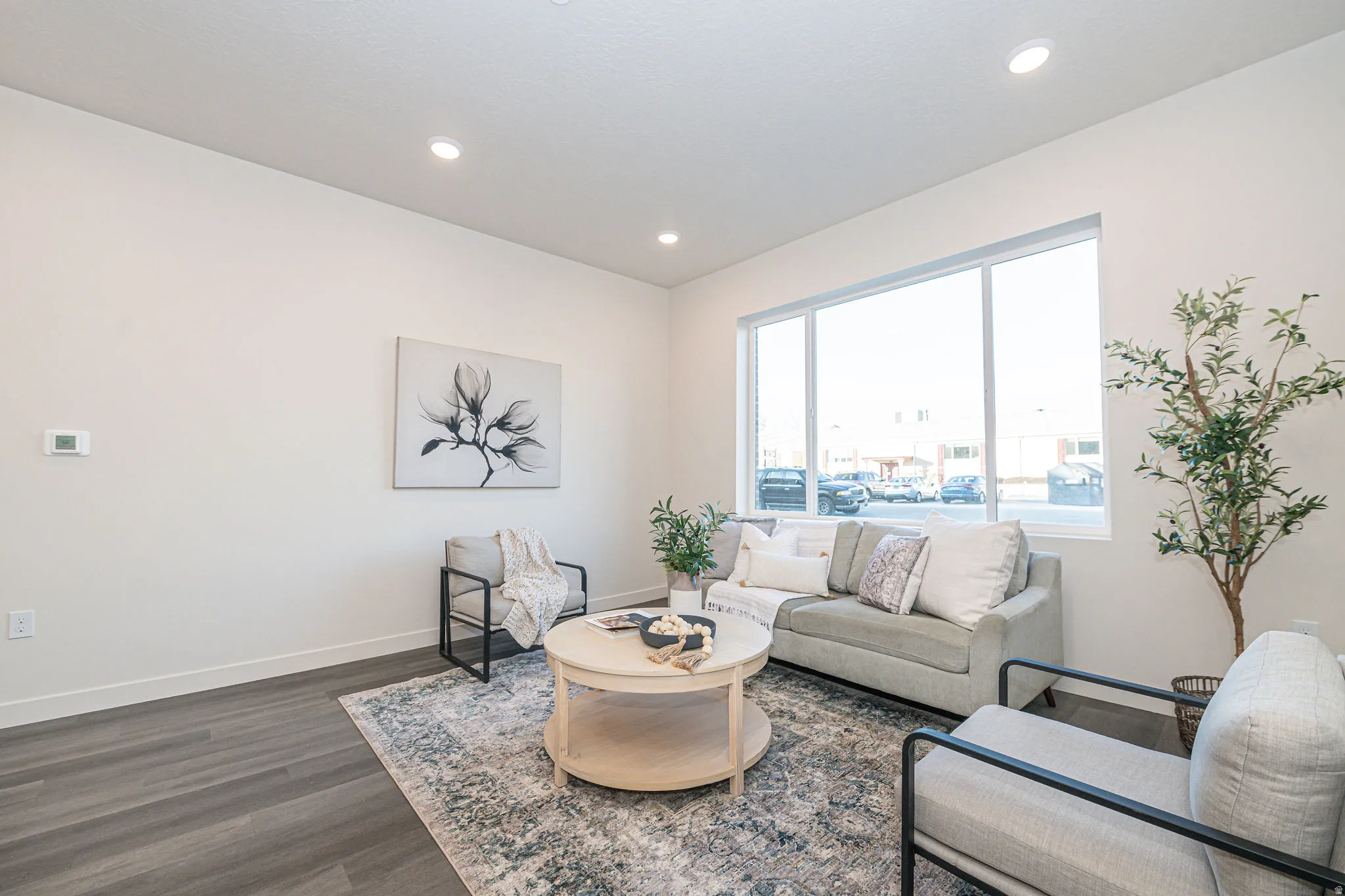 Living room with dark wood-type flooring and recessed lighting