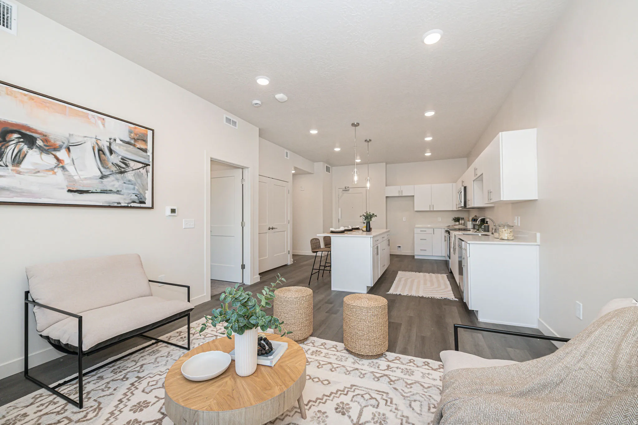 Living room with recessed lighting, dark wood finished floors, and a textured ceiling