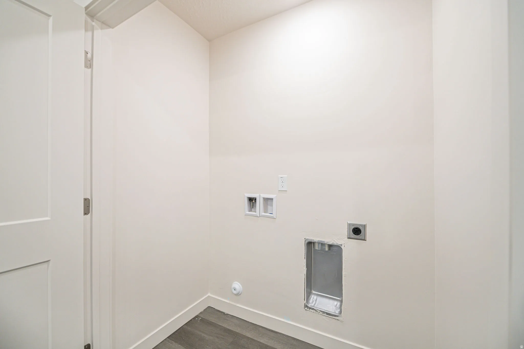 Laundry area with washer hookup, dark wood finished floors, and electric dryer hookup