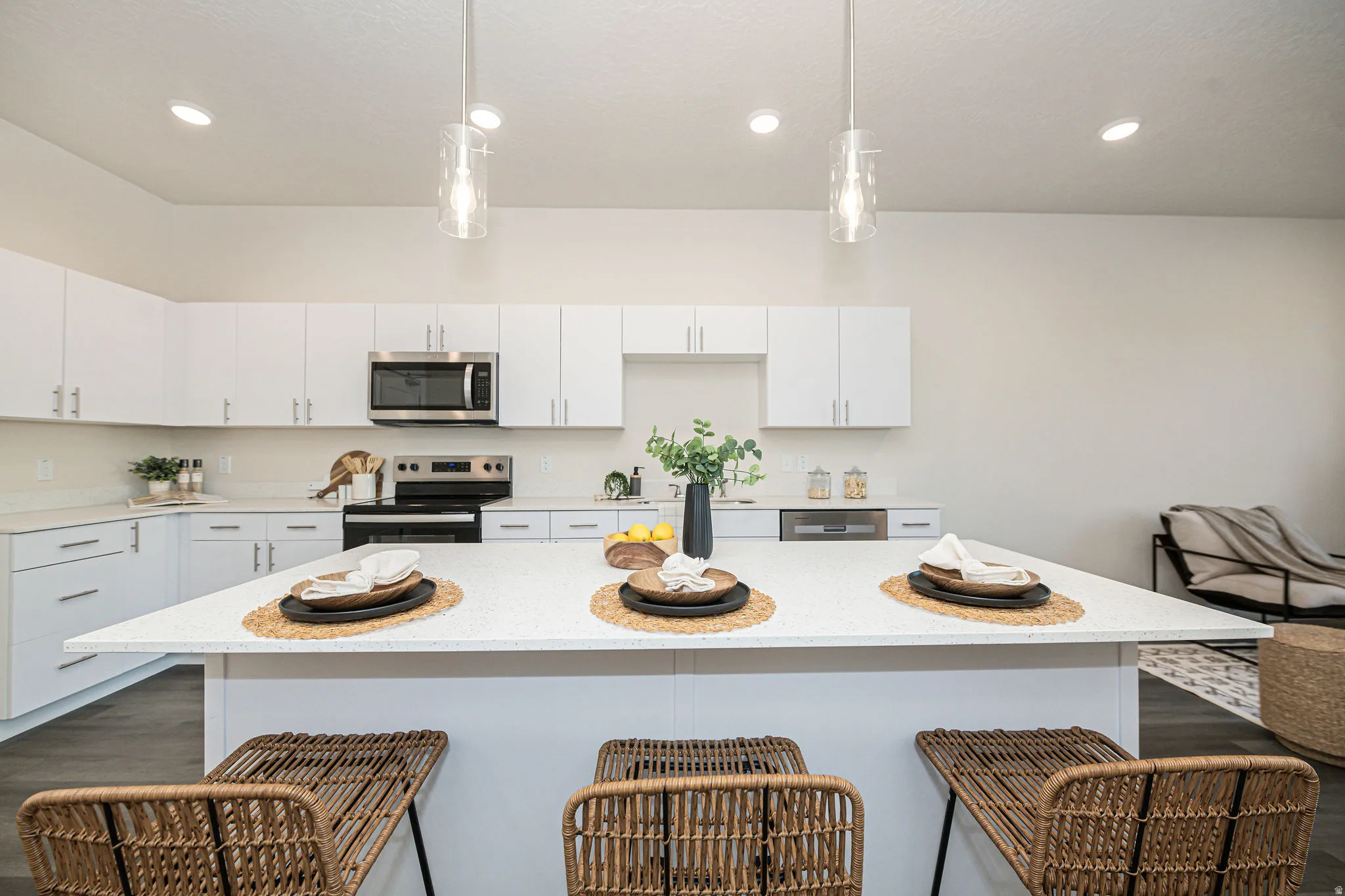 Kitchen with white cabinetry, stainless steel appliances, a breakfast bar, and recessed lighting