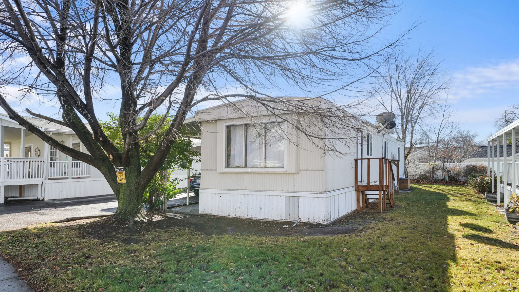 View of side of home with a yard