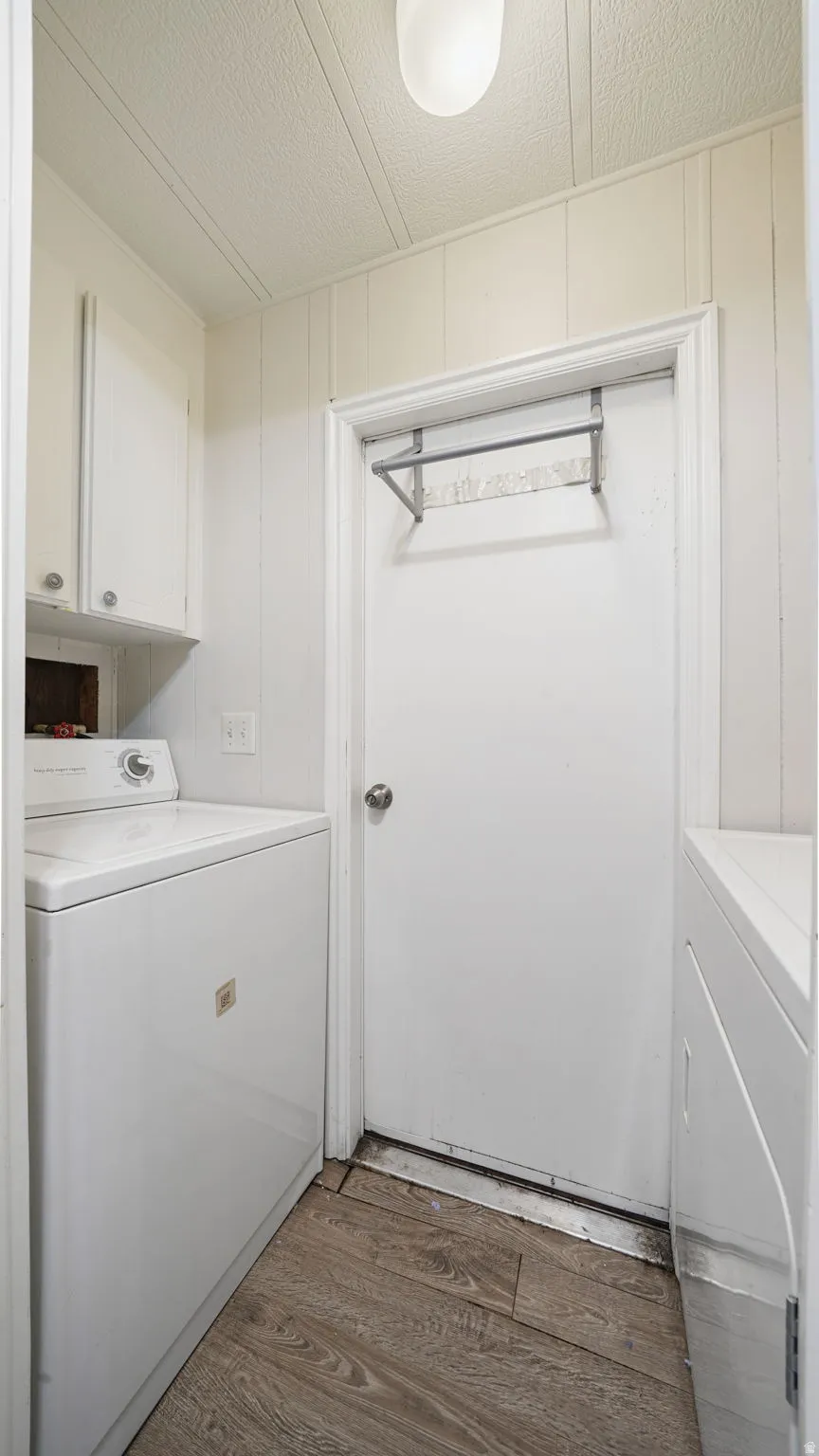 Laundry room featuring dark wood-style floors and hookup for a washing machine