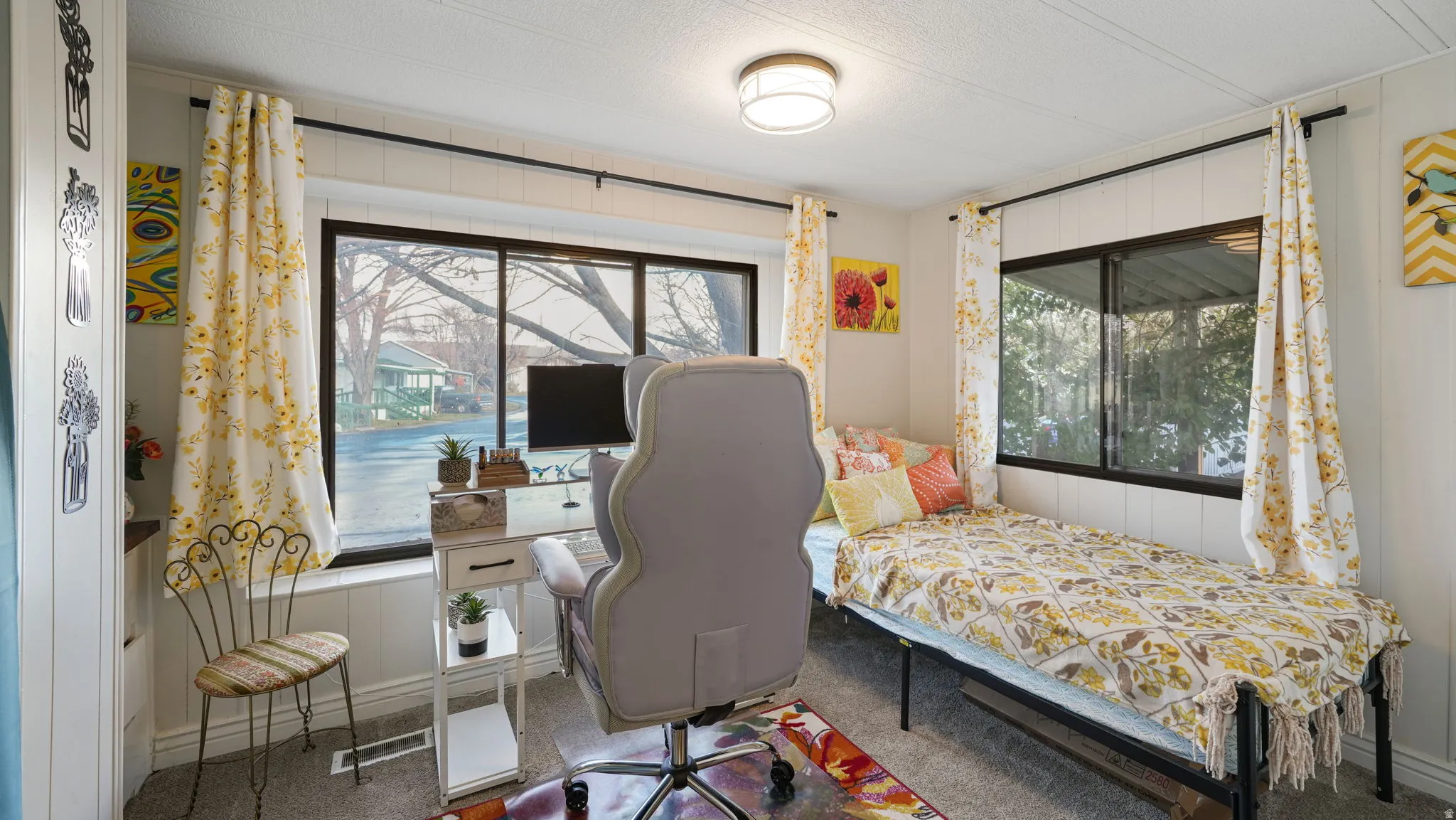 Carpeted bedroom with a textured ceiling and baseboards