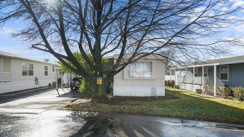View of home's exterior with a lawn and driveway