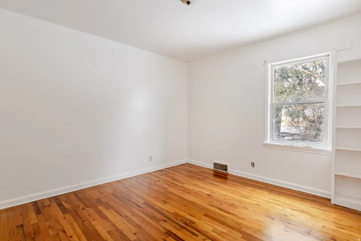 Spare room with light wood-style flooring and baseboards