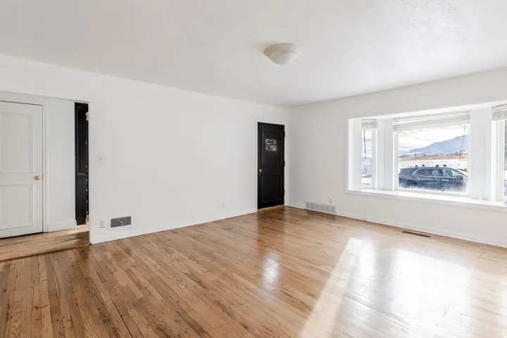 Empty room with light wood-style flooring and baseboards