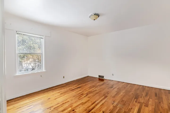 Empty room featuring light wood finished floors and baseboards