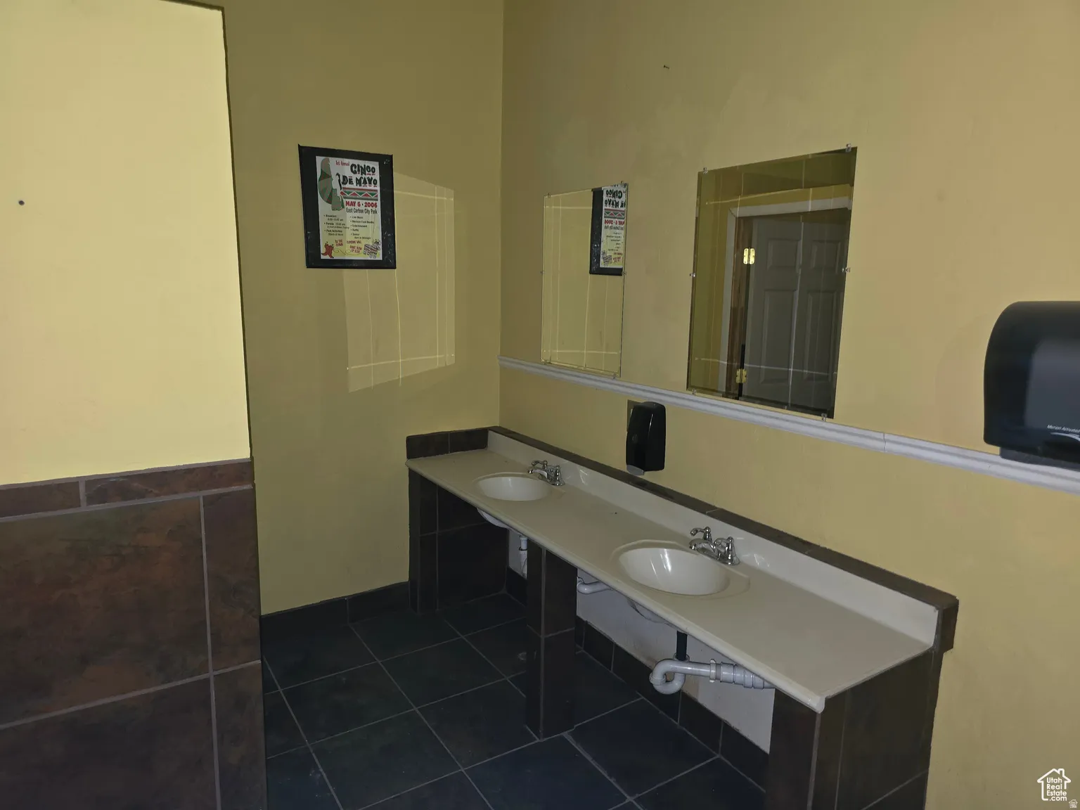 Bathroom with dark tile patterned floors and double vanity