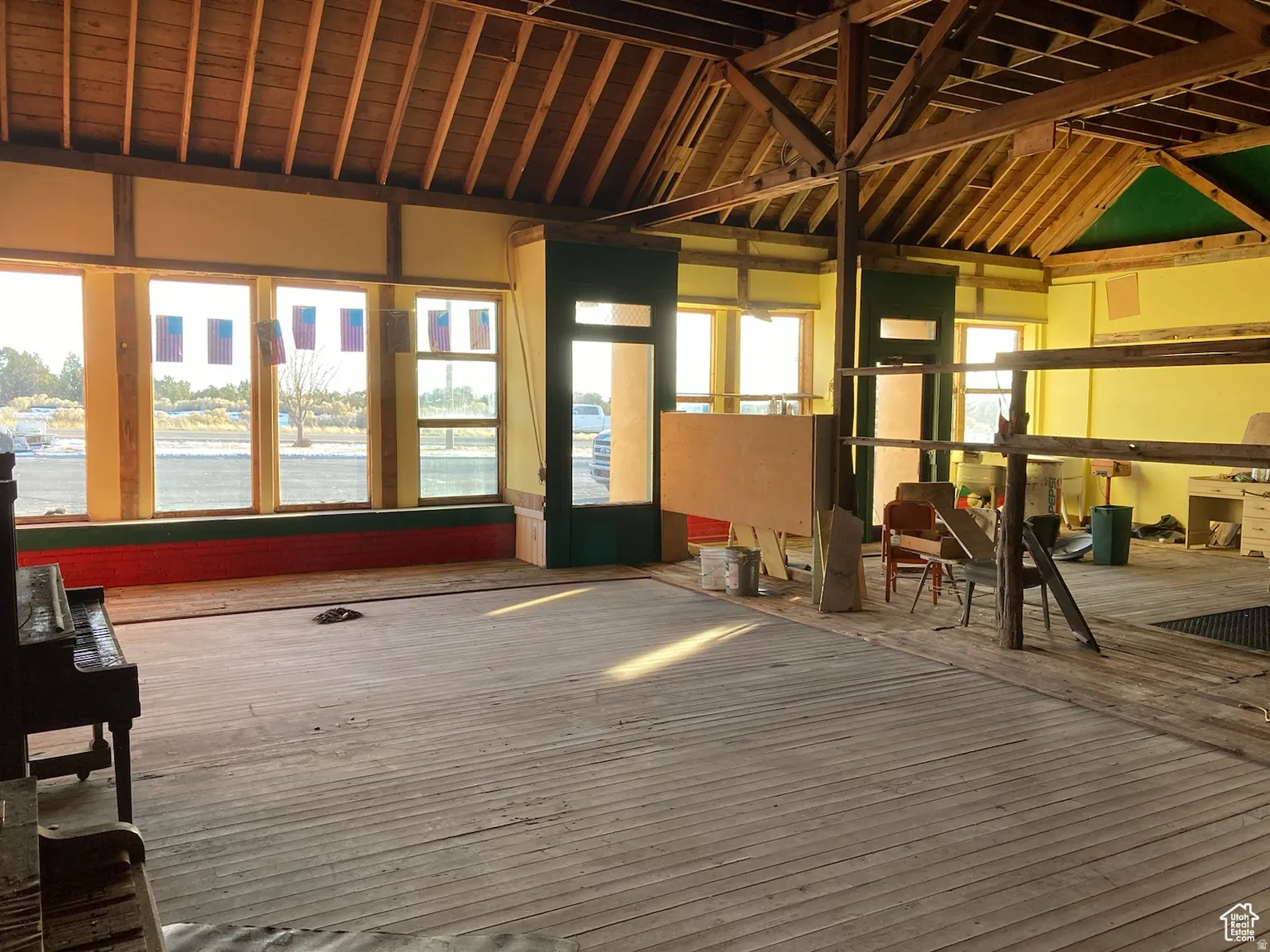 Miscellaneous room featuring hardwood / wood-style flooring, a water view, and lofted ceiling