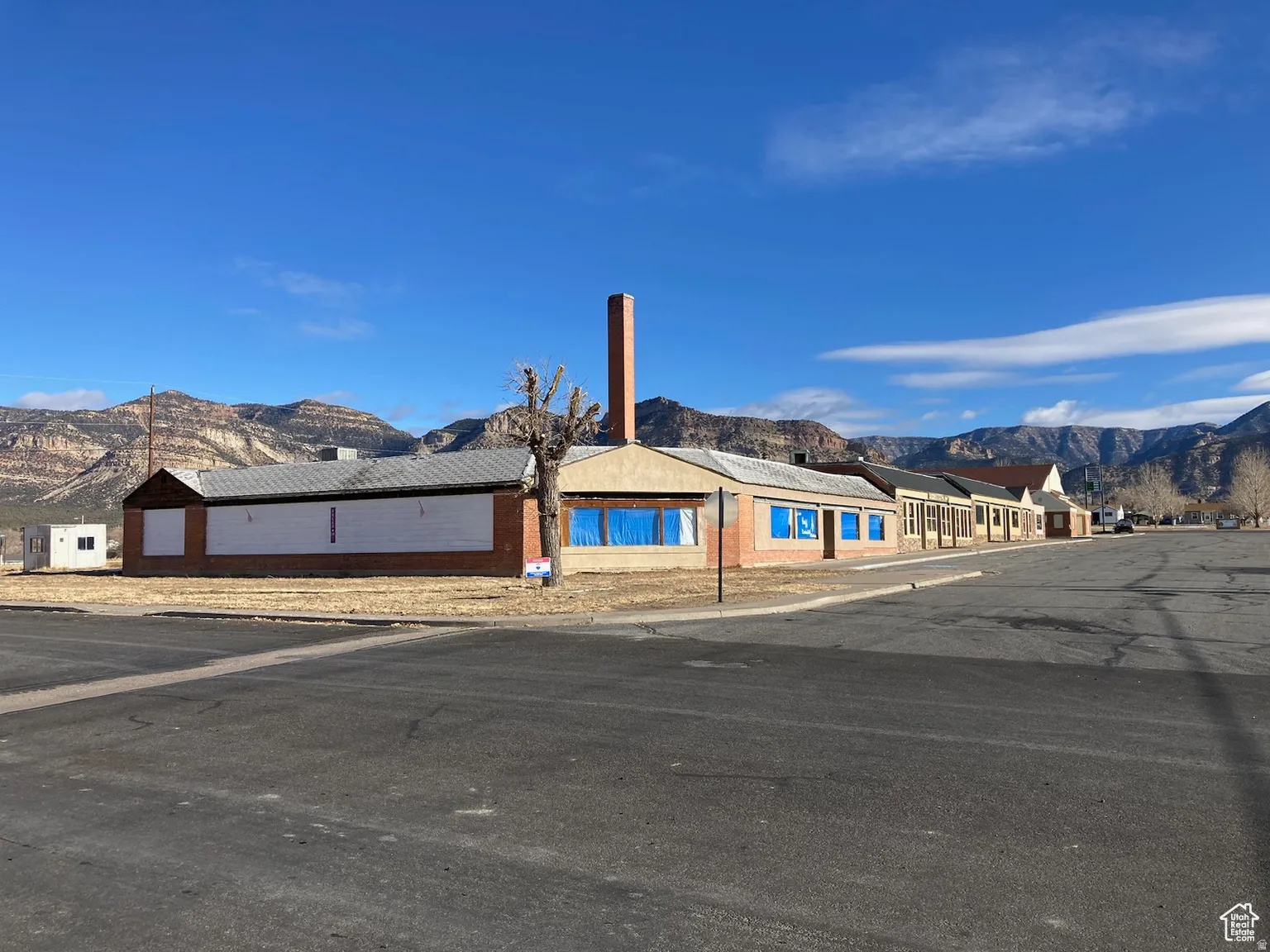 Single story home featuring a mountain view, brick siding, and a residential view