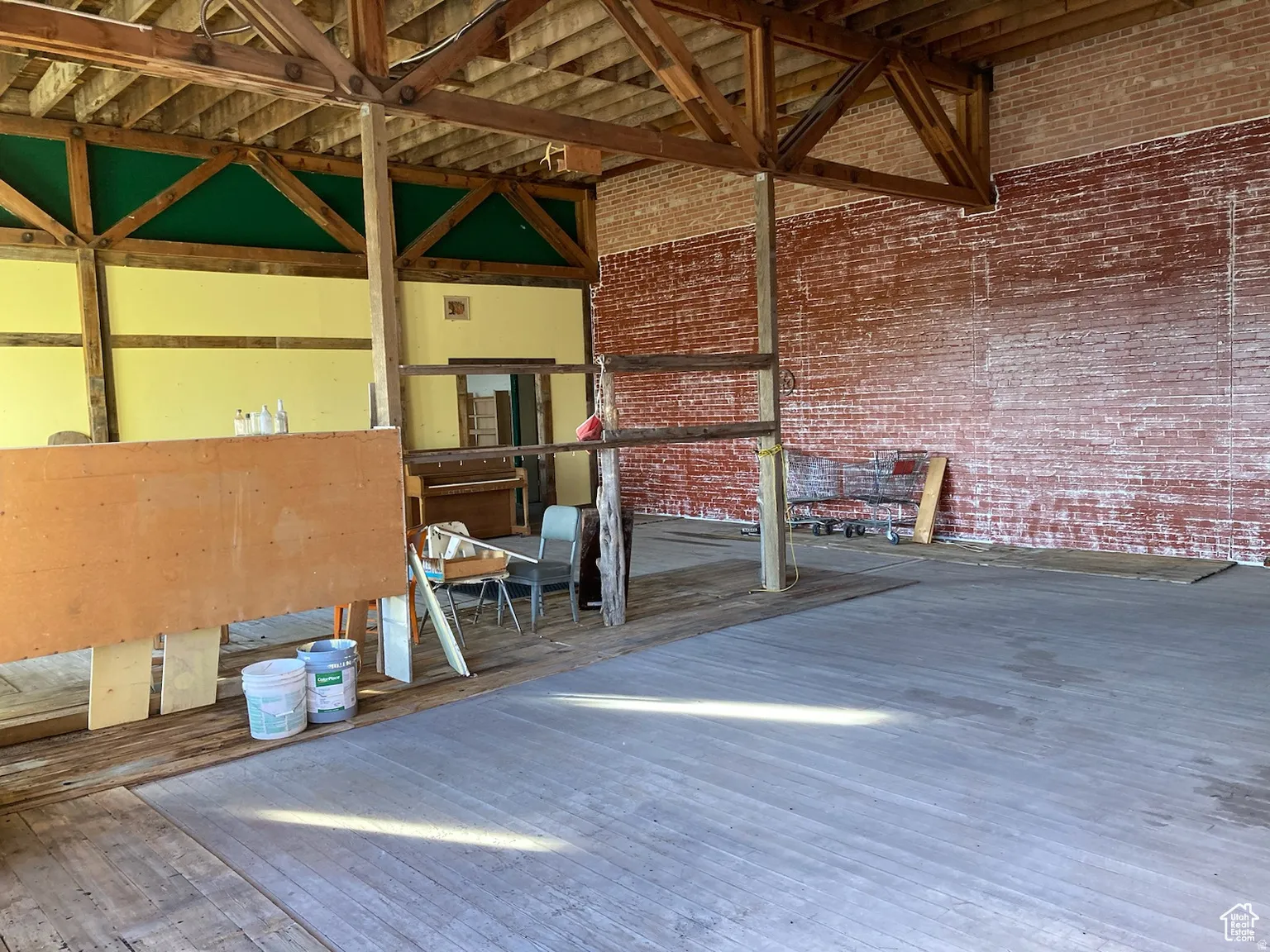 Misc room with brick wall and a towering ceiling