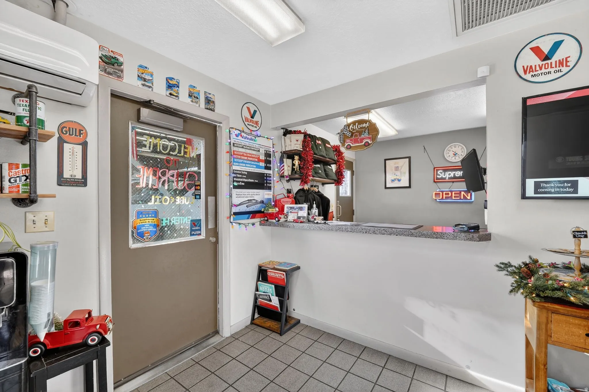 Kitchen featuring a wall mounted air conditioner and light tile patterned flooring