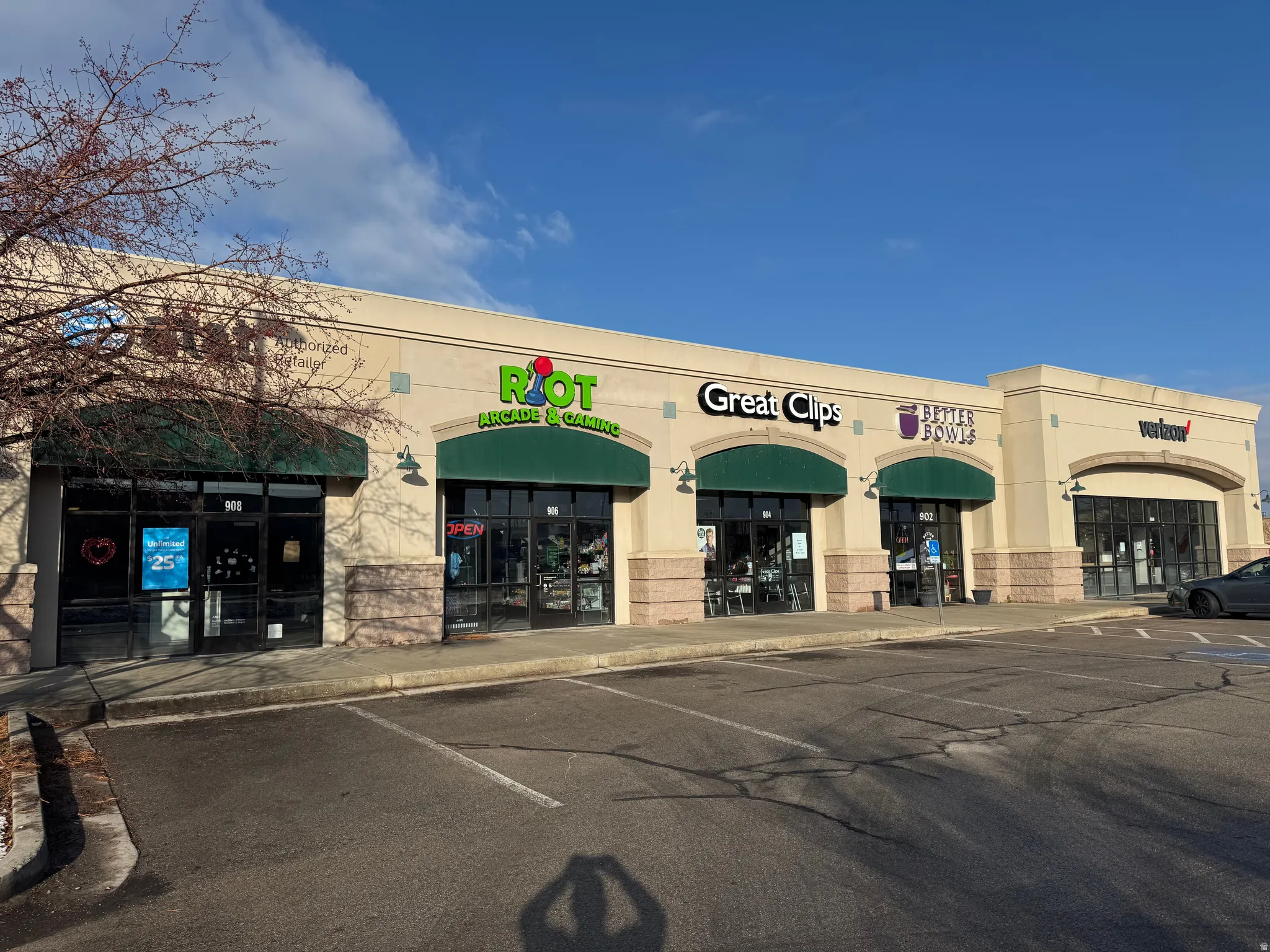 View of building exterior with uncovered parking